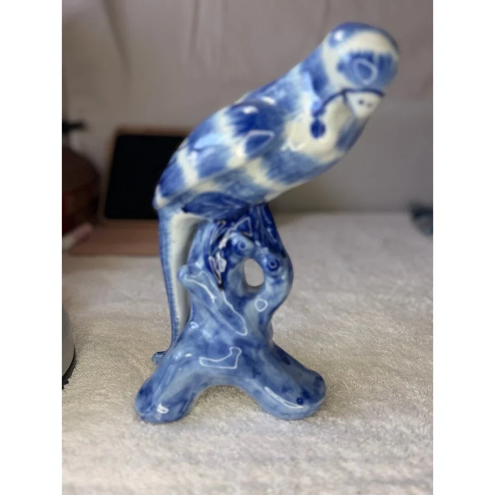 Chinoiserie blue and white porcelain parrot figurine, likely hand-painted.